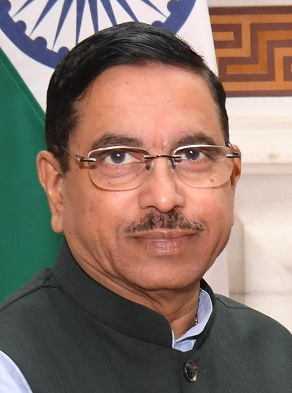 Head-and-shoulders portrait of Pralhad Joshi wearing rimless glasses and a dark bandhgala
