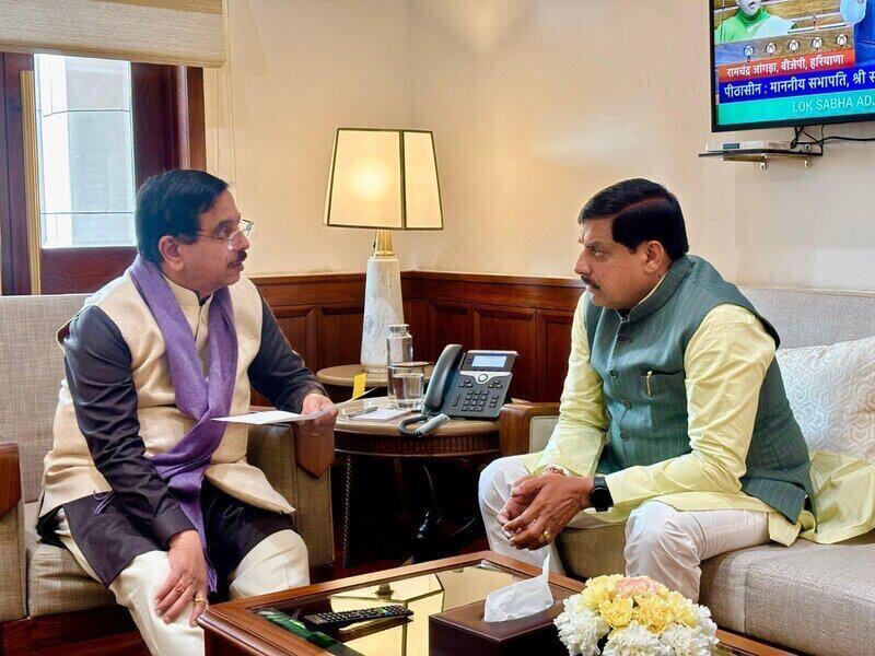 Pralhad Joshi and Madhya Pradesh Chief Minister Mohan Yadav seated in conversation in an office